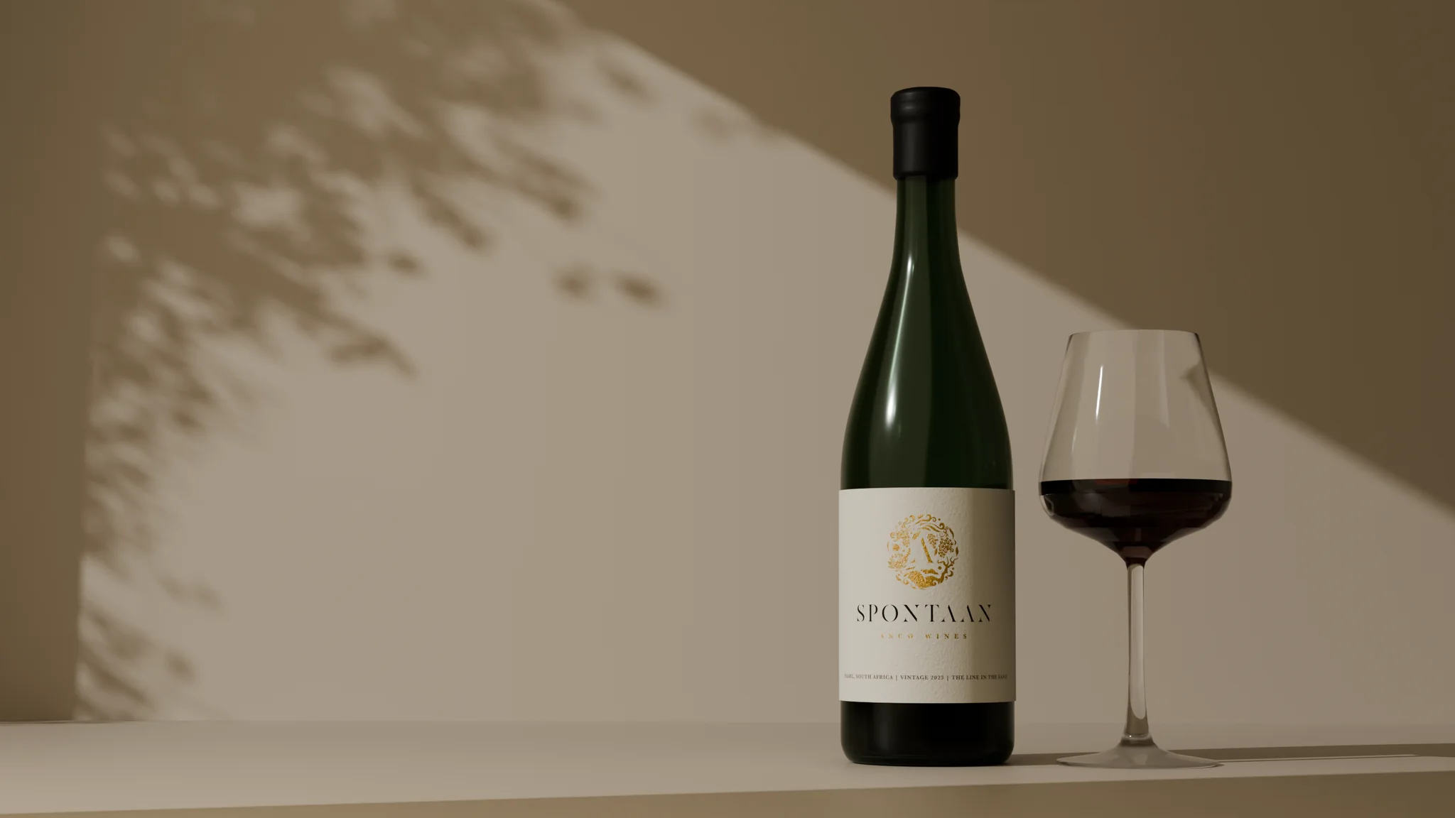 Anco Wines Spontaan bottle and a glass of red wine in warm studio light